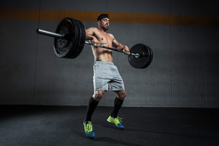 Young man working on a clean and jerk.